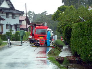 長沼・宮東で、消防団が消防ポンプを使い雨水排水から藤島川に汲み上げ、懸命の作業